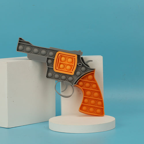 Toy pop it pistol on display with a blue background.